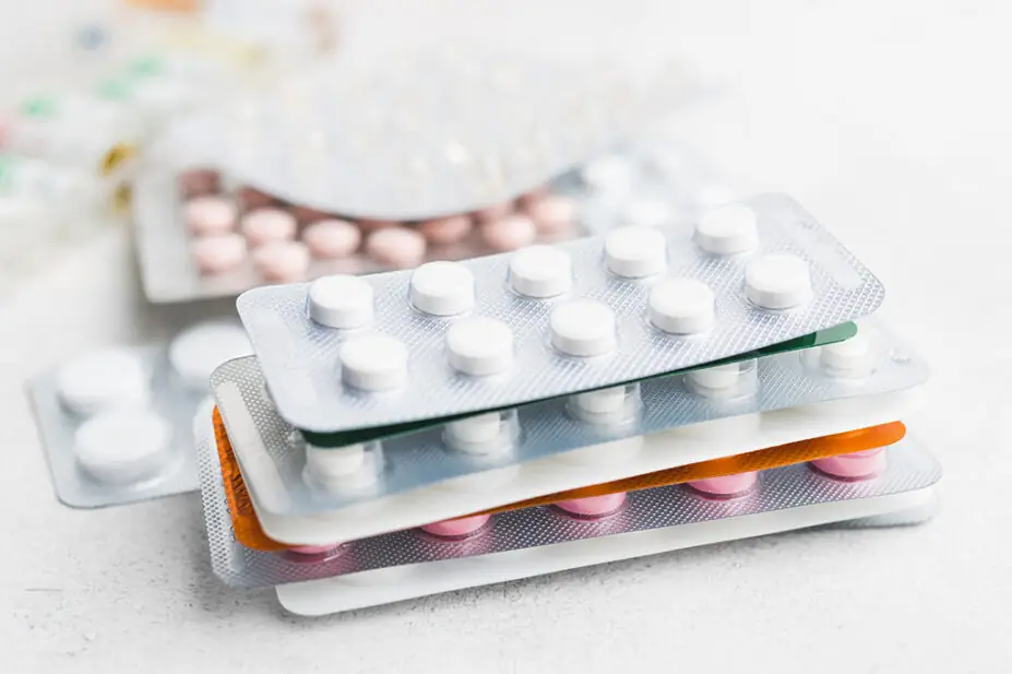 A pile of various packs of medicine tablets