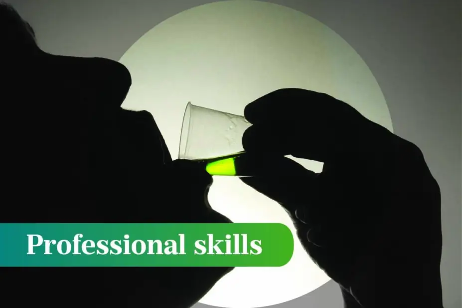 Silhouetted man drinks a green liquid 'methadone' from a plastic cup