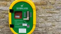 Defibrillator on a wall for cardiac emergency use in Dorset, UK