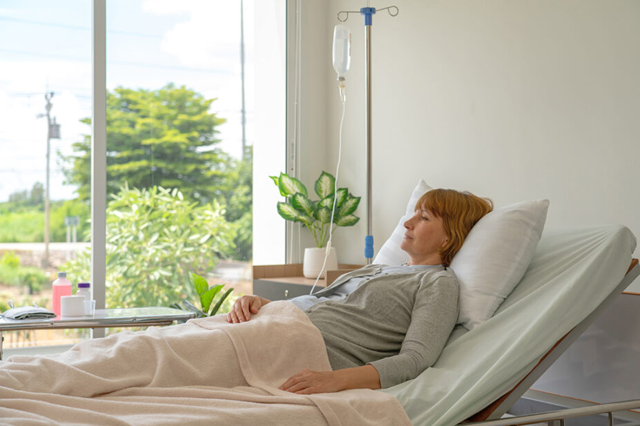 Female patient at home in a hospital bed, suggestive of palliative care