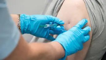 A patient receives a COVID-19 vaccination