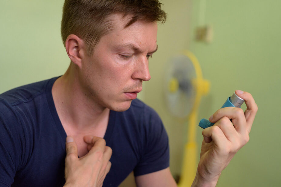 A man uses an inhaler for asthma