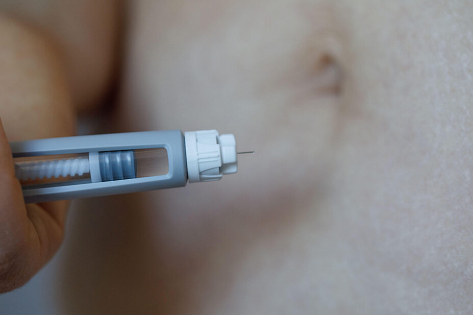 A person prepares to use a weight-loss pen