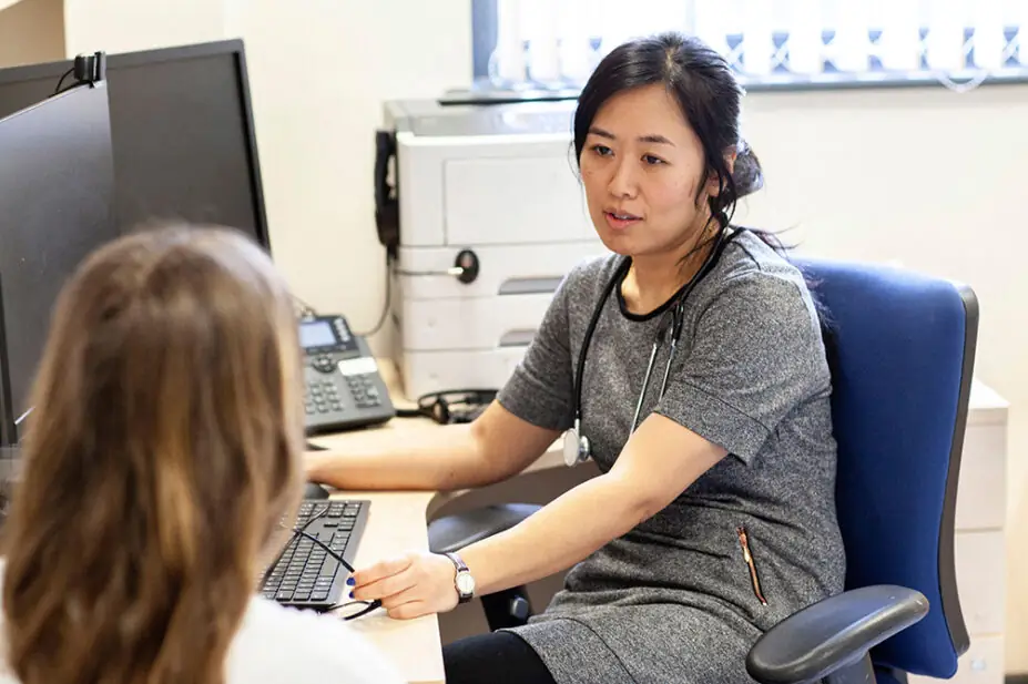 A clinician consults with a patient