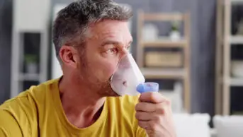 A man uses a nebuliser