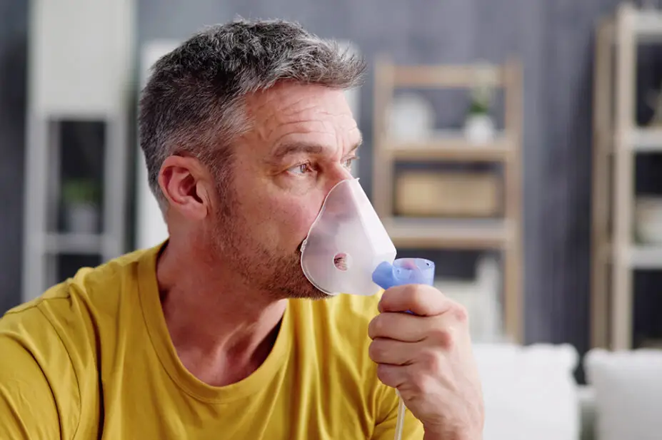 A man uses a nebuliser