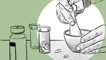 Tablets being crushed in a pestle and mortar