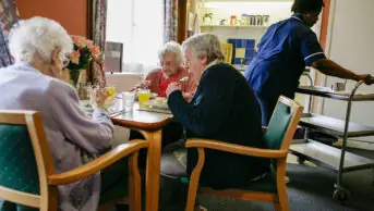 Residents in a care home have lunch