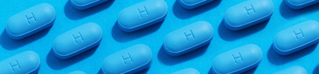 PrEP pills laid out in a rows on a blue background