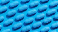 PrEP pills laid out in a rows on a blue background