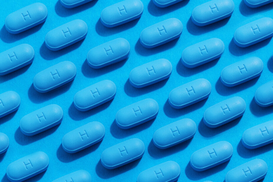 PrEP pills laid out in a rows on a blue background