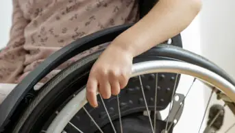 A person steers a wheelchair