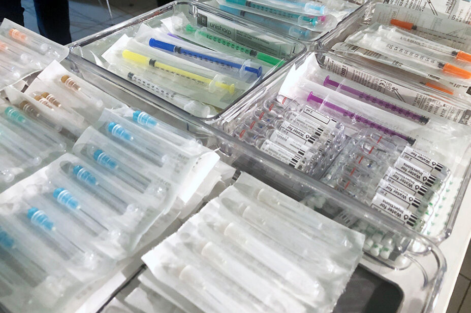 Packets of needles on display at a drug consumption room