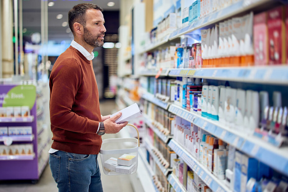 A customer shops for over-the-counter medicine in a pharmacy