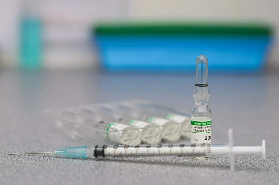 Vials of morphine solution and a needle