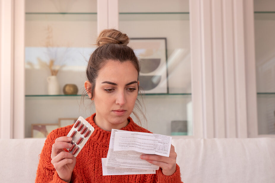 Female patient reads medication information leaflet