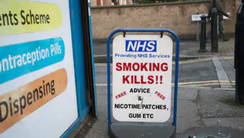 NHS 'smoking kills' sign outside a pharmacy in London