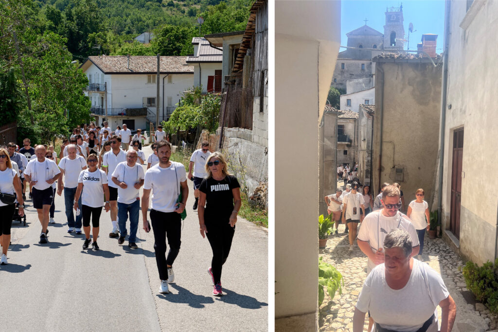 People walking towards the camera, town can be seen behind