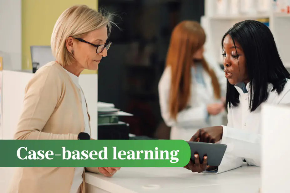 Pharmacist standing at pharmacy with tablet in hands and having consultation with senior woman
