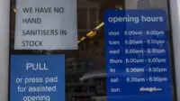 Signage on the entrance door of Pharmacy in Southend-on-Sea, Essex. Opening times are are visible