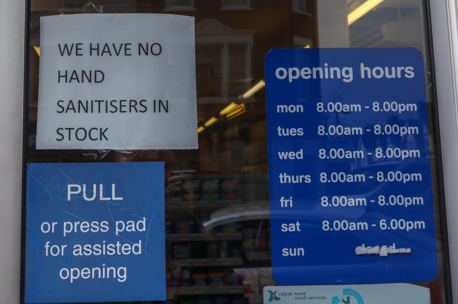 Signage on the entrance door of Pharmacy in Southend-on-Sea, Essex. Opening times are are visible