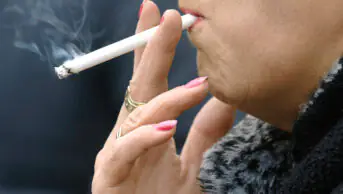 A woman smokes a cigarette