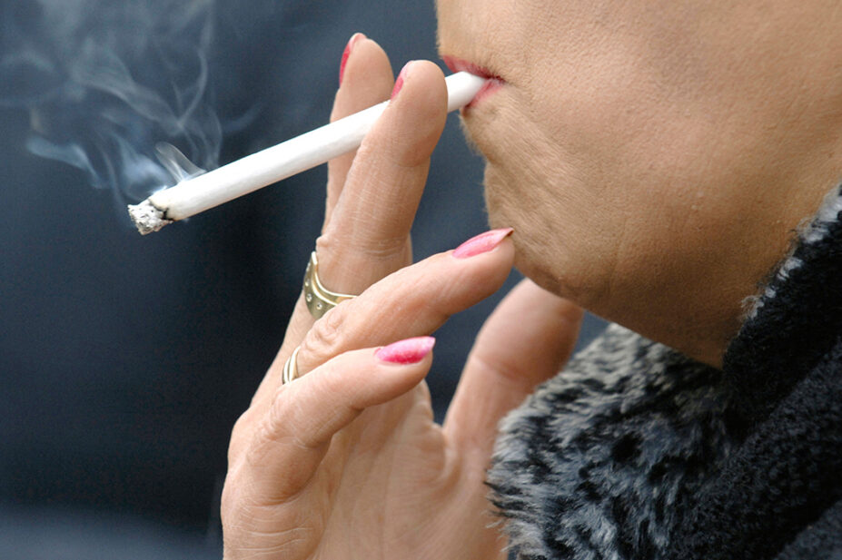 A woman smokes a cigarette