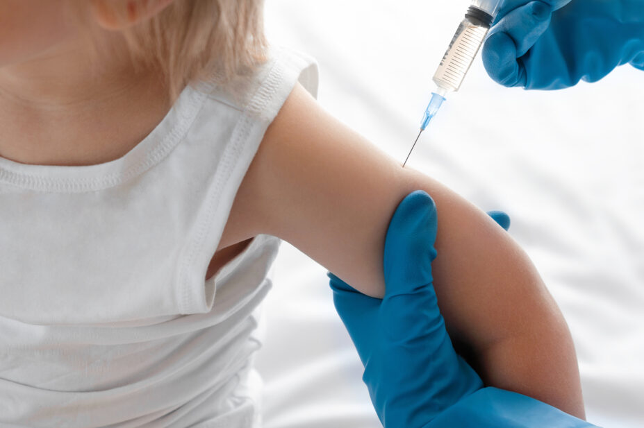 Pharmacist vaccinating 18 month old