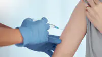 A patient receives a vaccination