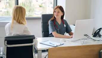 GP consultation taking place between female doctor and female patient