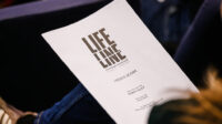 Someone holding a Lifeline script during rehearsals
