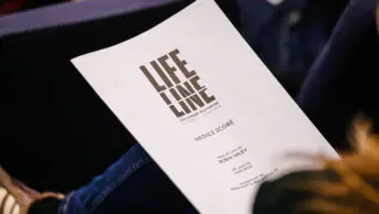 Someone holding a Lifeline script during rehearsals