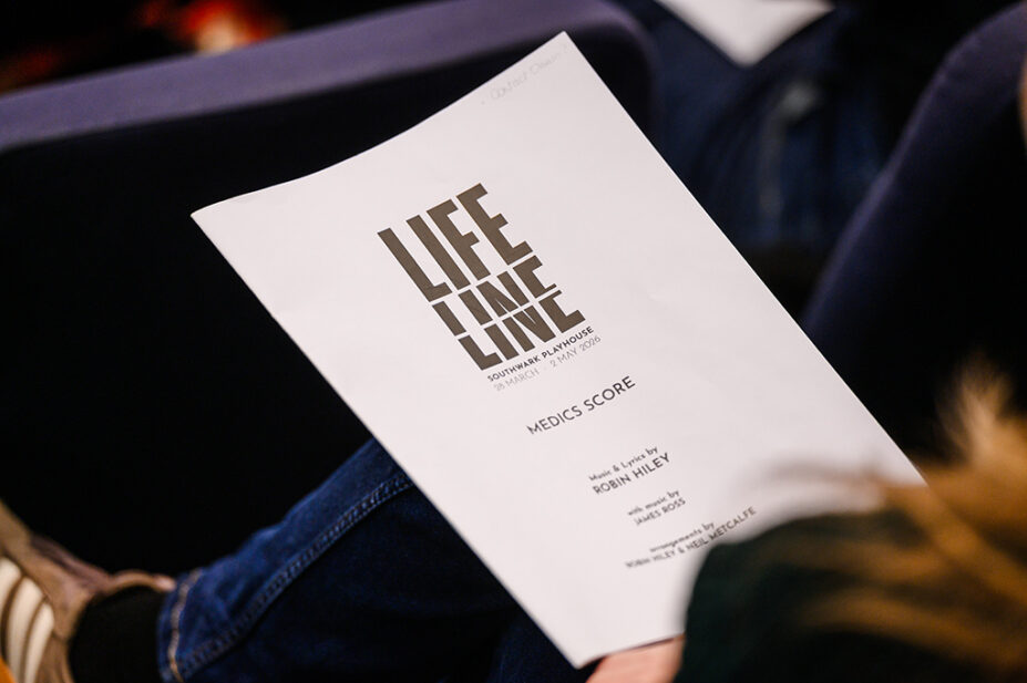 Someone holding a Lifeline script during rehearsals