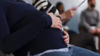 Close up of pregnant woman in a waiting room