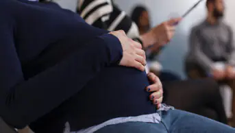 Close up of pregnant woman in a waiting room