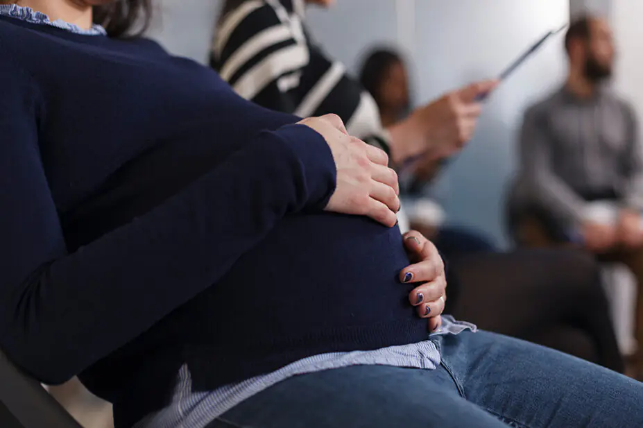 Close up of pregnant woman in a waiting room