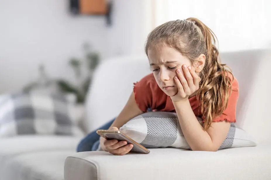 A teenage girl uses a smartphone