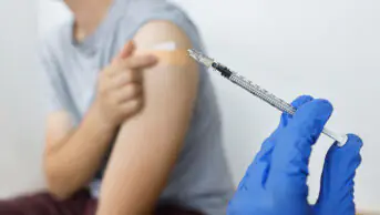 A young person receives a COVID-19 vaccination