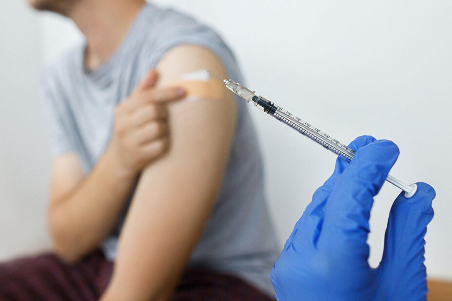 A young person receives a COVID-19 vaccination