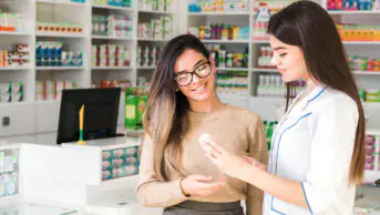 A pharmacist consults with a patient