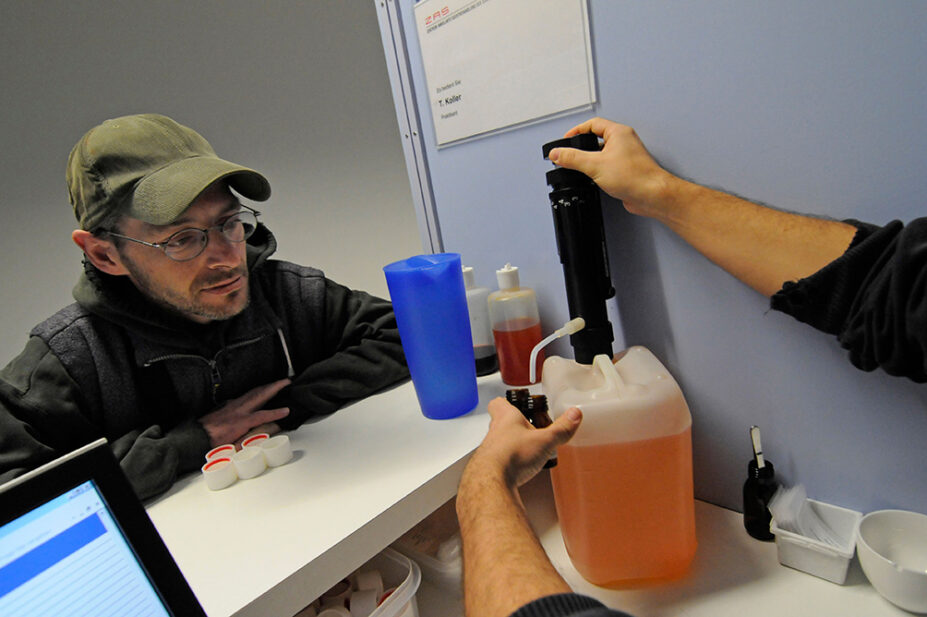 A healthcare professional prepares methadone for a patient