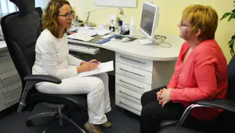 A healthcare professional consults with a patient