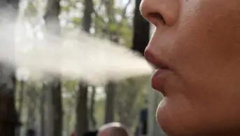 A woman smokes a cigarette