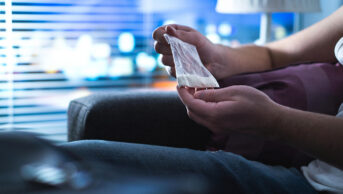 A man holds a bag illegal drugs