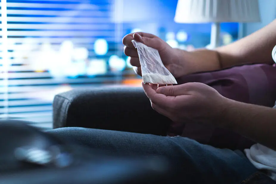 A man holds a bag illegal drugs