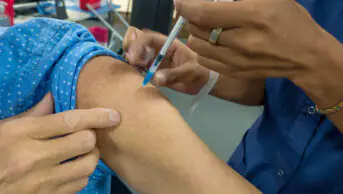 A patient receives a vaccination