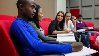 University students take notes in class