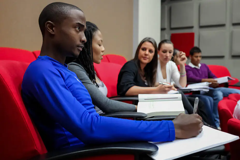 University students take notes in class