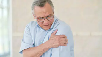 An older man experiences pain in his arm