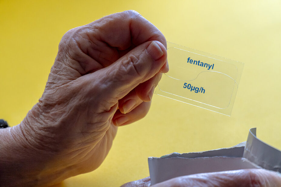 An older woman uses an opioid patch